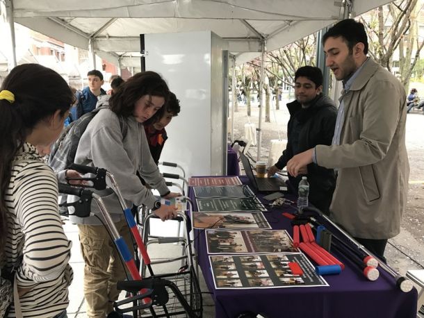 Visiting junior high school students learn about a project designed to make canes and other assistive devices safer for the elderly