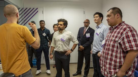 Alumni listen as a member of the Veterans Future Lab gives a presentation on his project