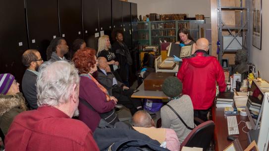 Alumni watch a demonstration by Poly archivist Lindsay Anderberg