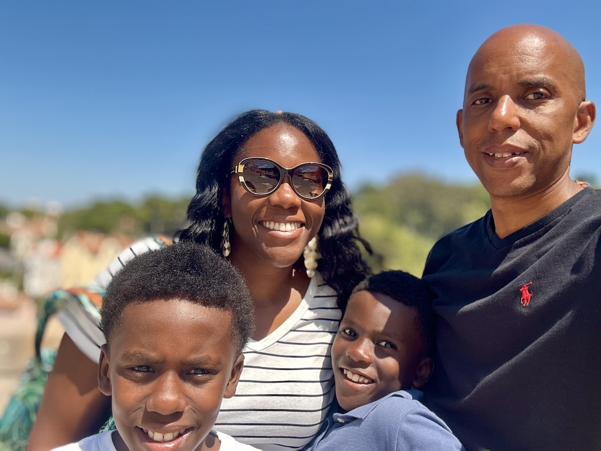 smiling parents with 2 young sons