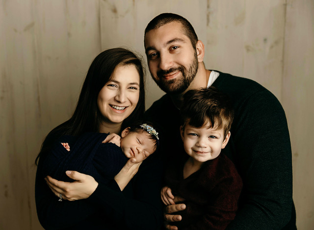 smiling parents with 2 young children